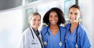 Three diverse doctors smiling together